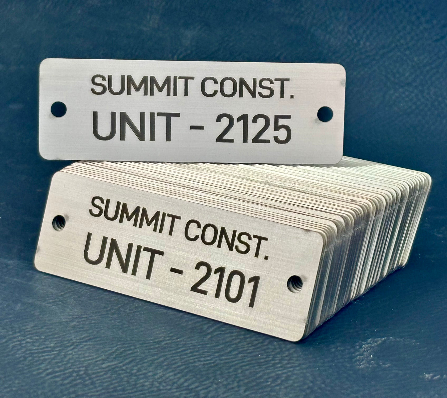 stack of sequential metal tags for construction company