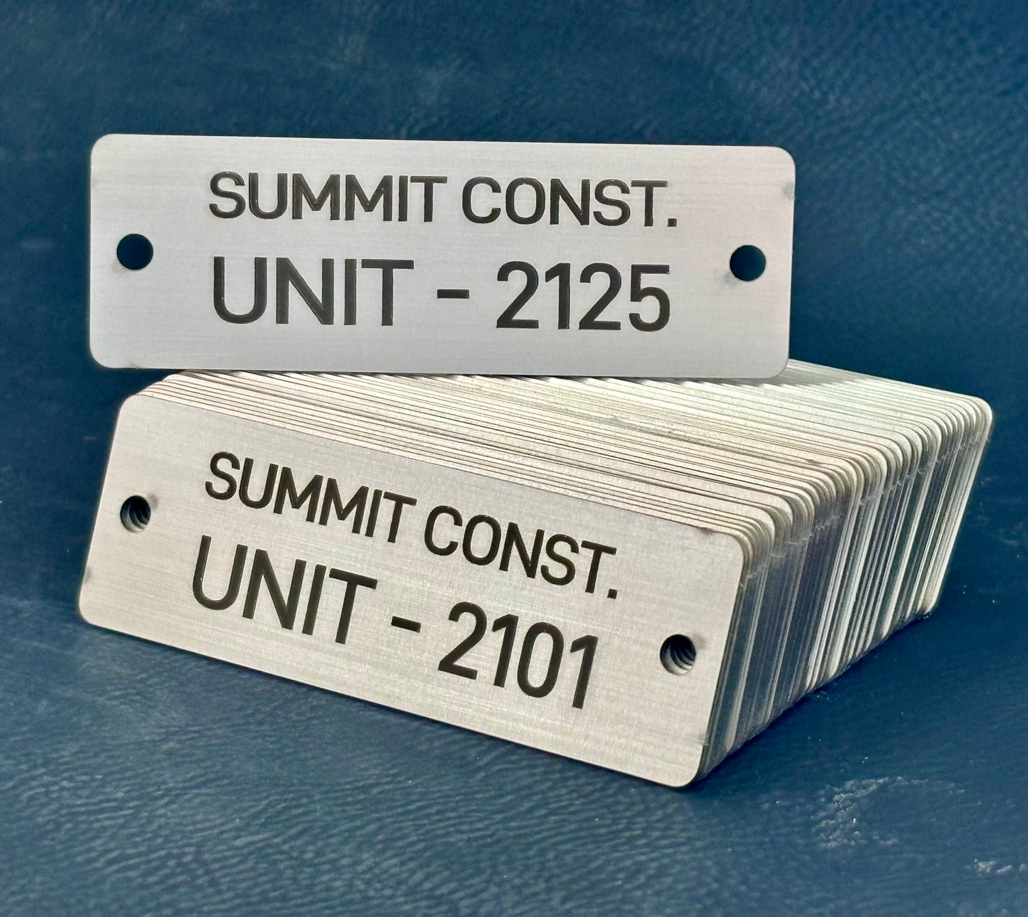 stack of sequential metal tags for construction company