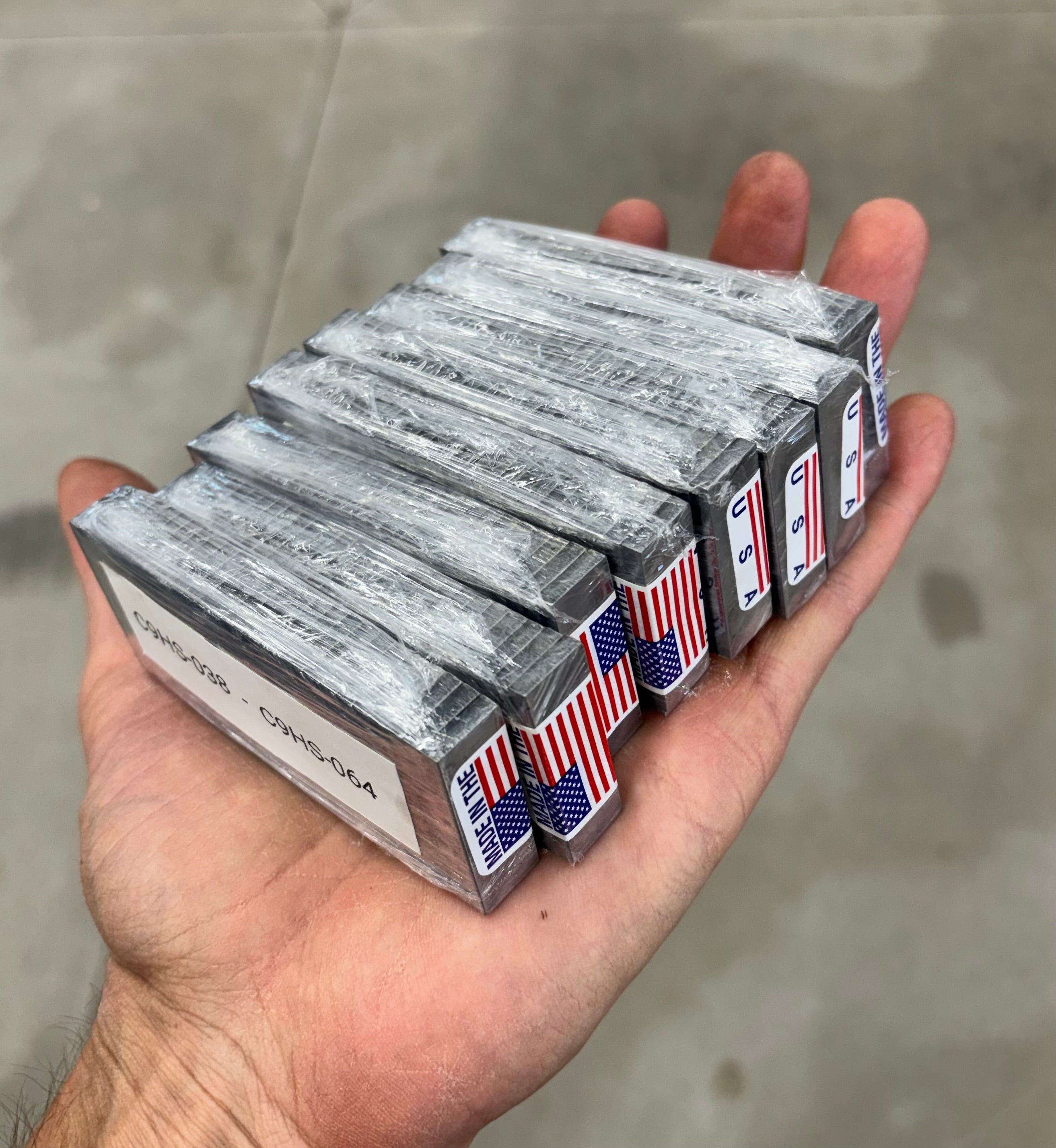 Bundles of engraved metal tags produced by Custom Cutouts