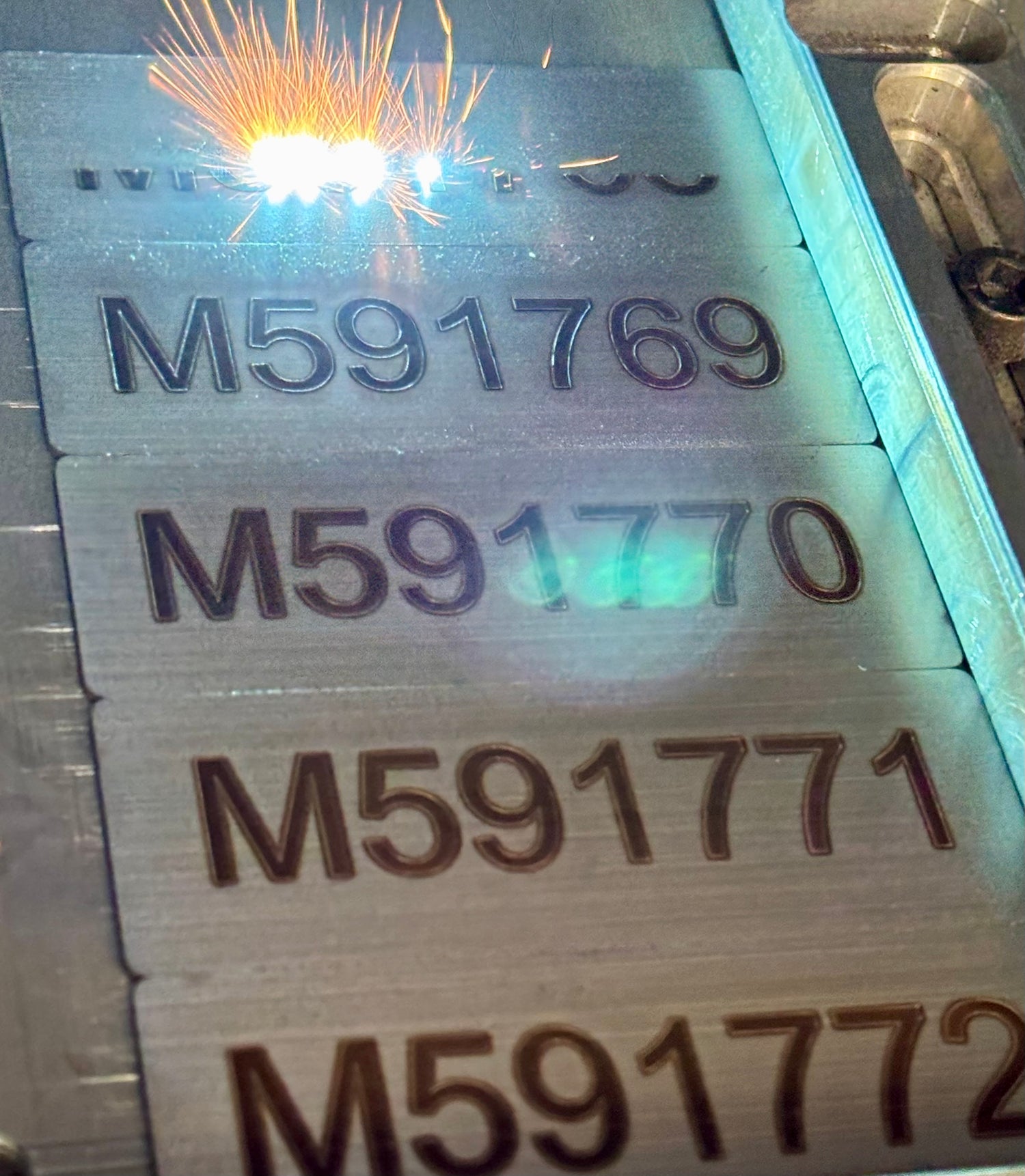 Custom metal tags being laser engraved