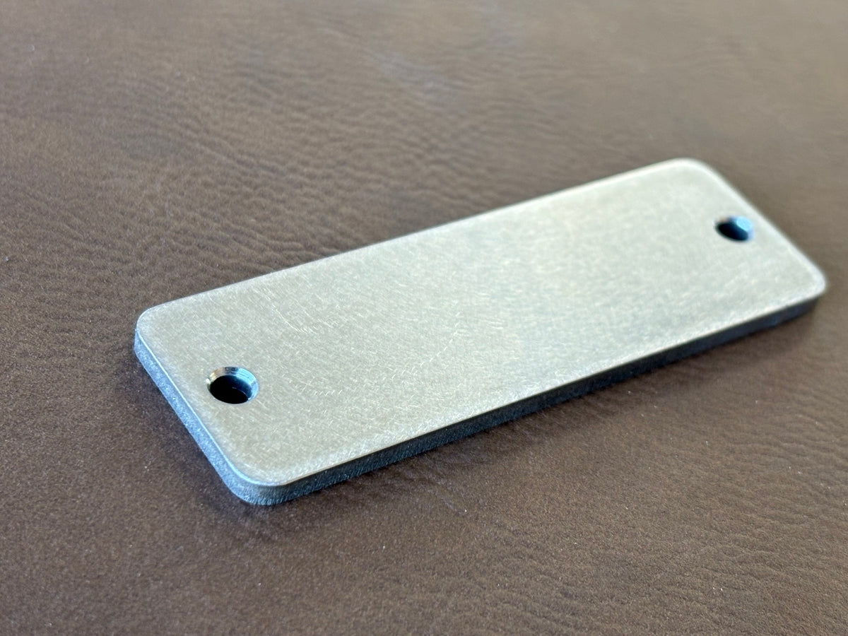 1" x 3" premium stainless nameplate – angled blank showing thickness and chamfered holes
