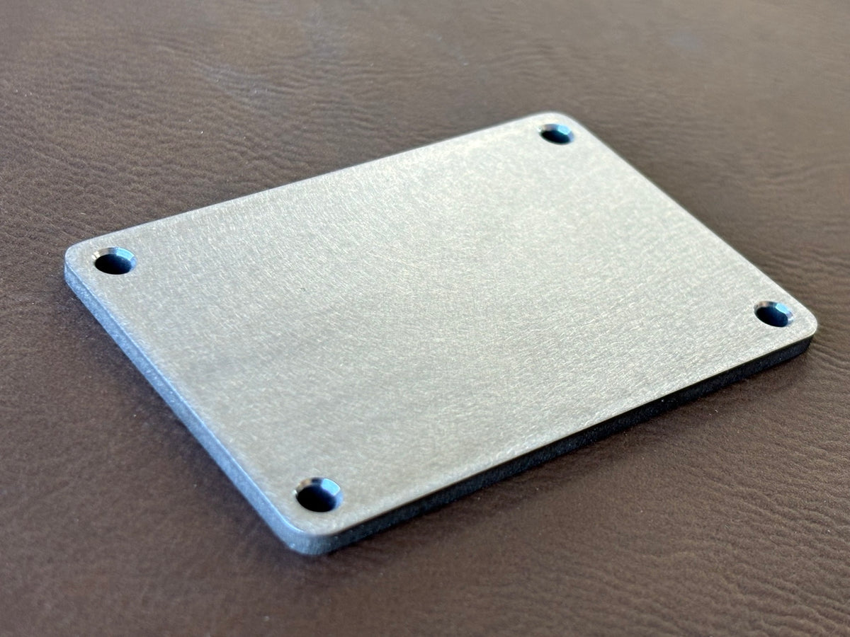 2" x 3" premium stainless nameplate – angled blank showing thickness and chamfered holes