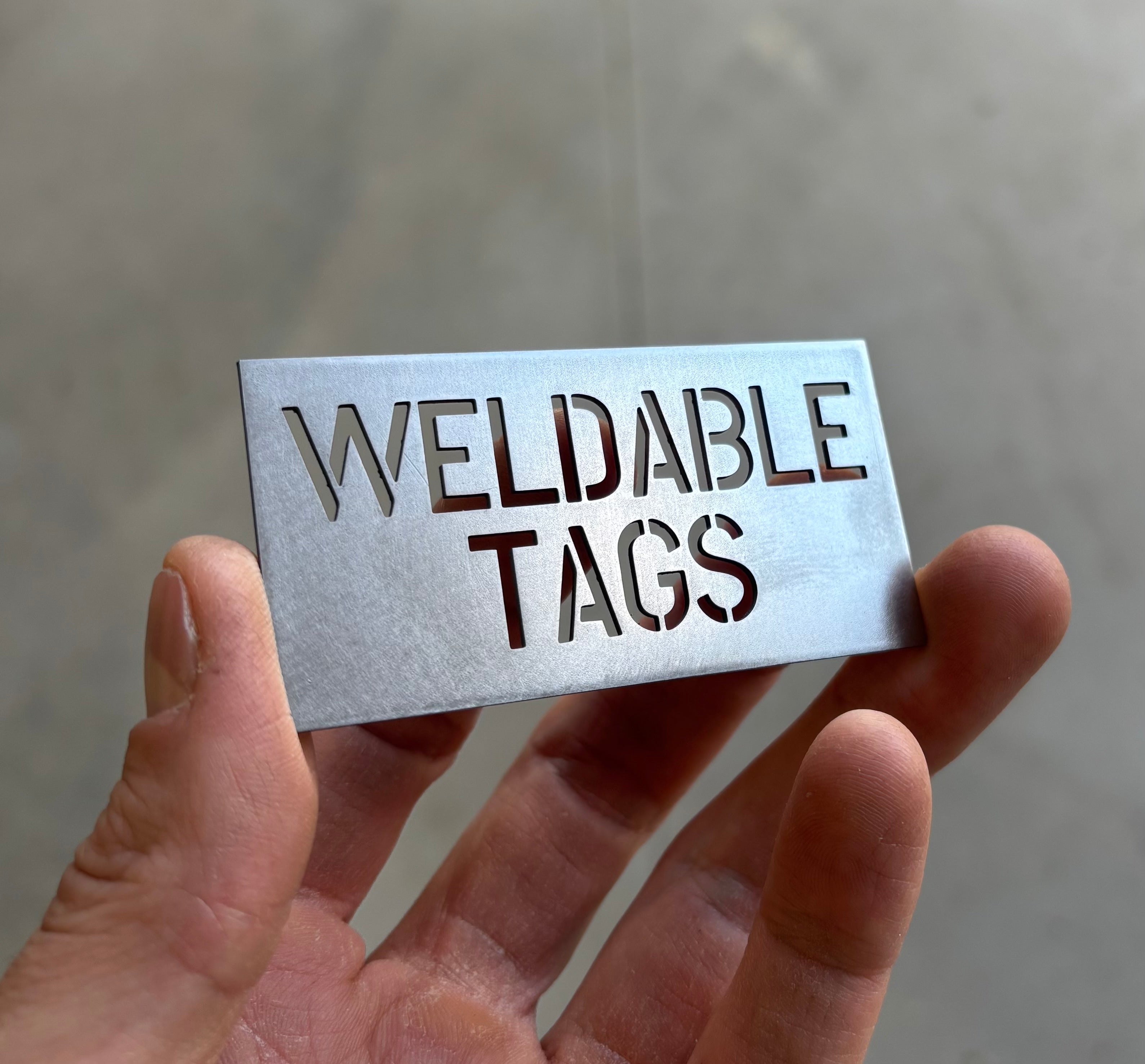Steel weld tag with cut-through identification text
